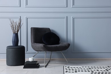 Photo of Stylish stool, chair and vase near light grey wall indoors, space for text