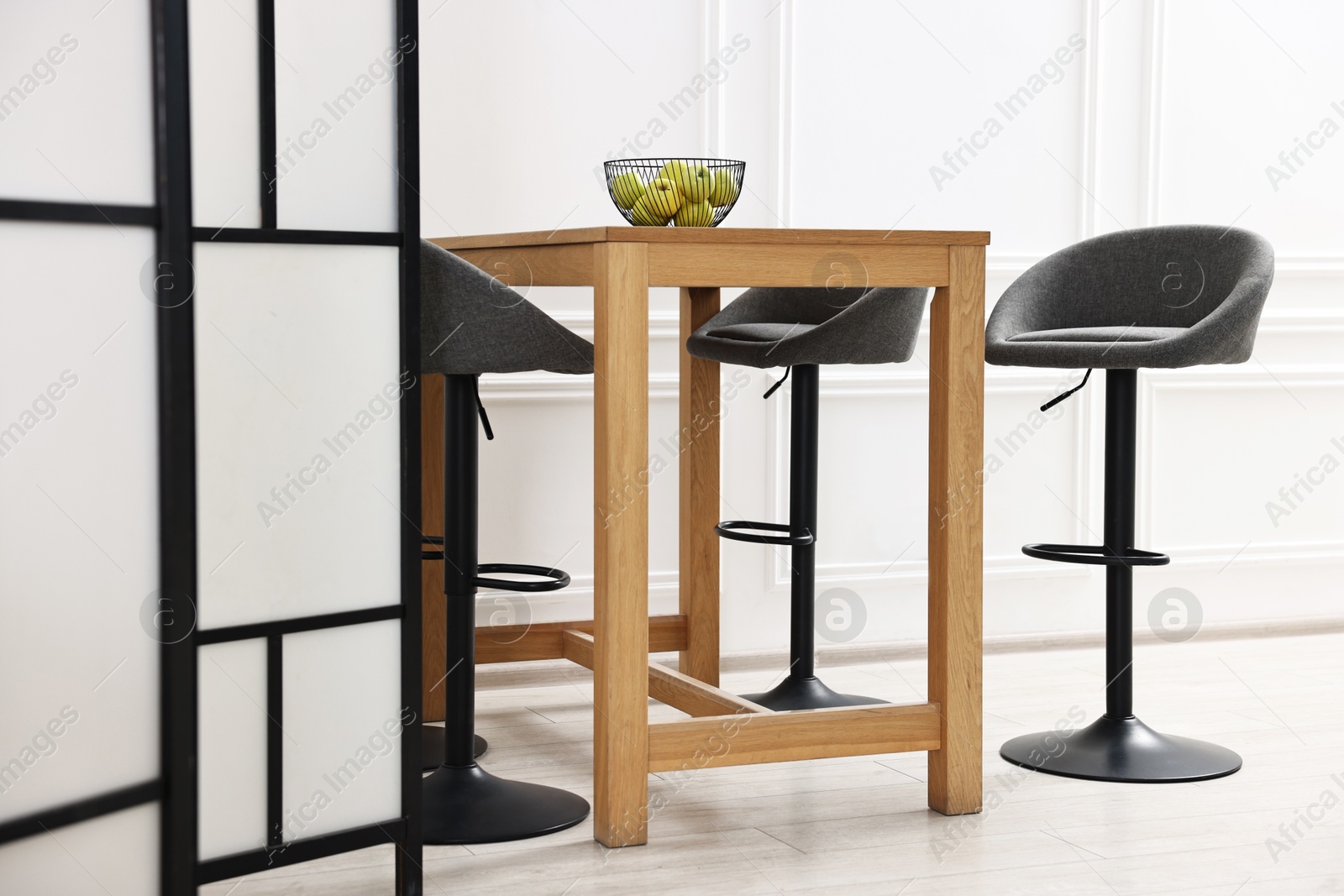 Photo of Bar stools, table and folding screen indoors