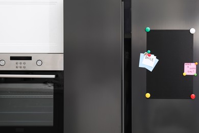 Photo of Magnetic board and notes on refrigerator in kitchen