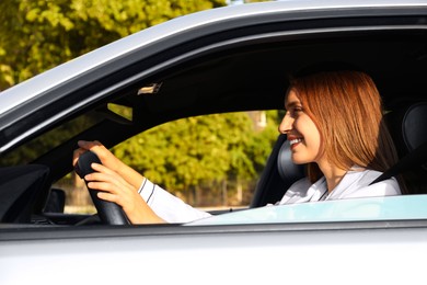 Woman holding steering wheel while driving car