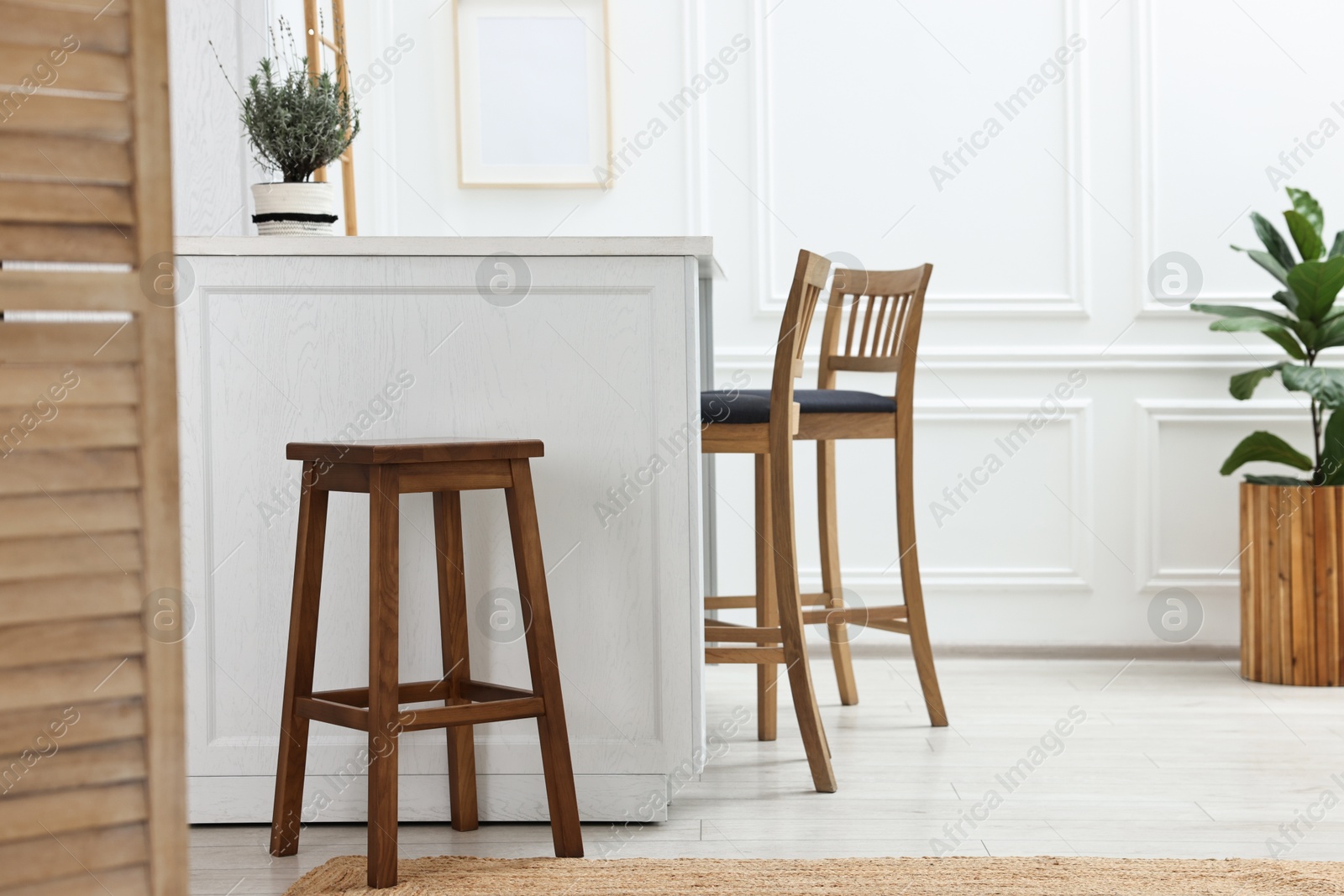 Photo of Stylish dining room with bar stools. Interior design