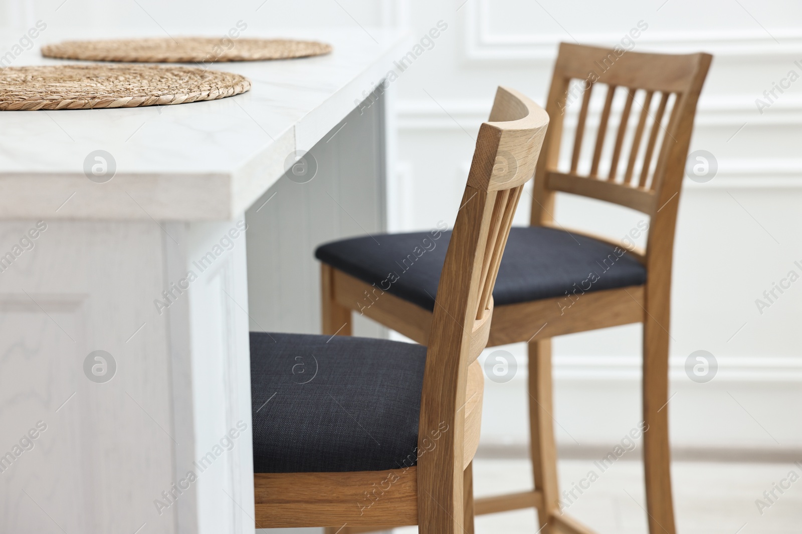 Photo of Stylish dining room with bar stools. Interior design