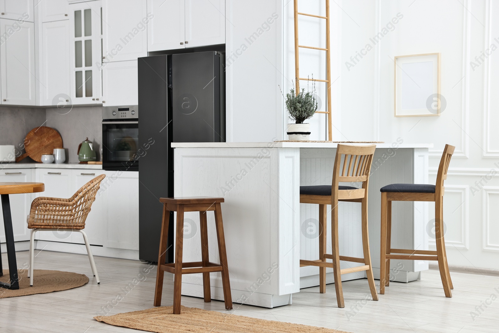 Photo of Stylish kitchen with bar stools. Interior design