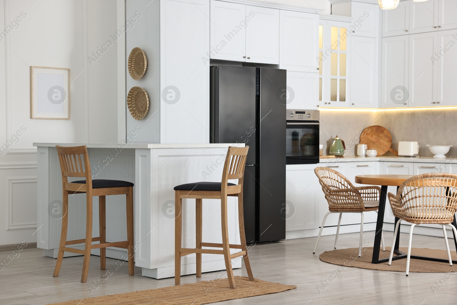 Photo of Stylish kitchen with bar stools. Interior design