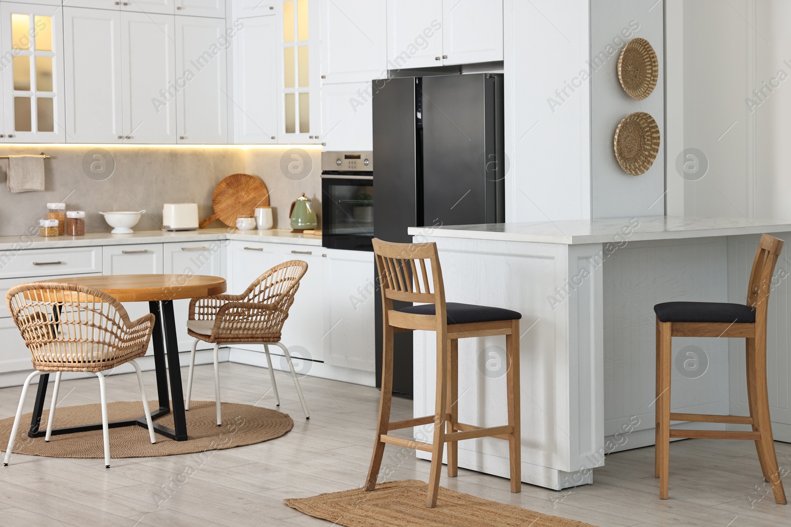 Photo of Stylish kitchen with bar stools. Interior design