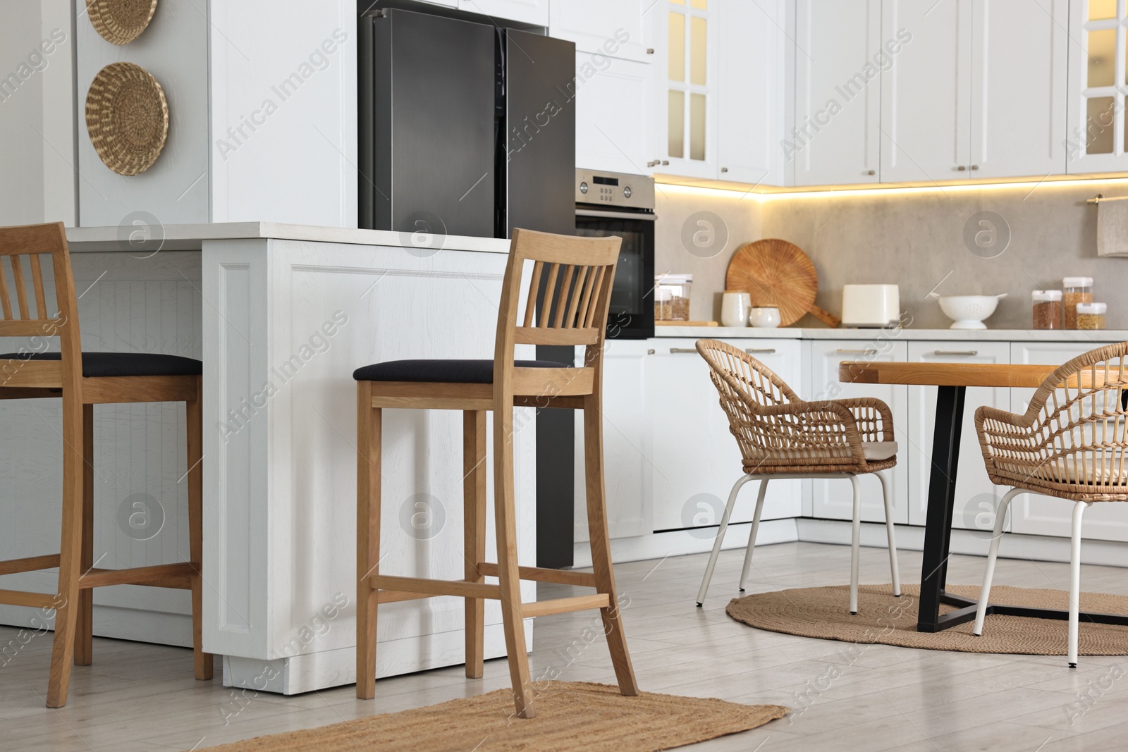 Photo of Stylish kitchen with bar stools. Interior design