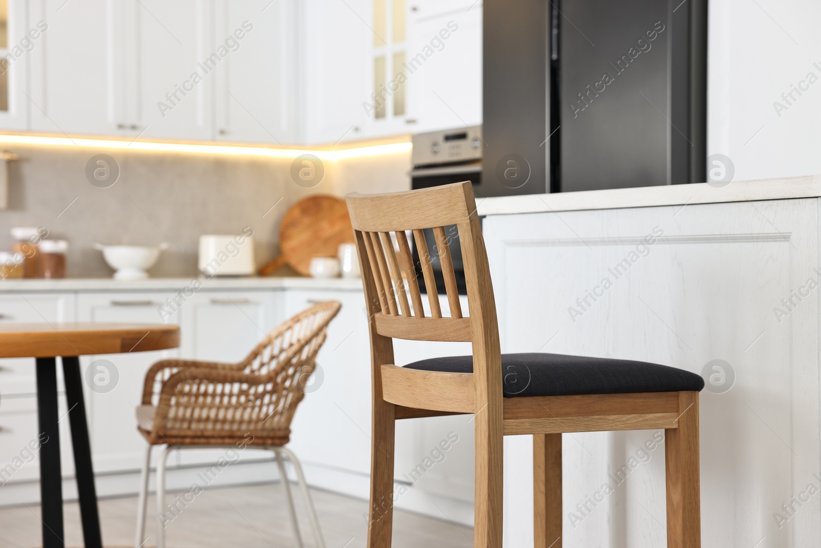 Photo of Stylish kitchen with bar stool. Interior design