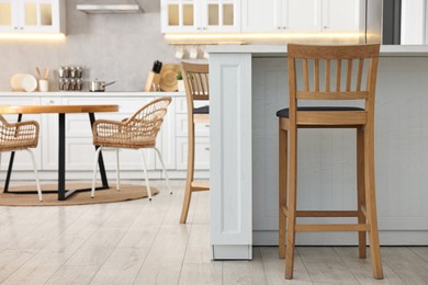 Photo of Stylish kitchen with bar stools. Interior design