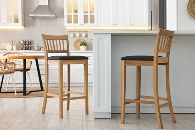 Photo of Stylish kitchen with bar stools. Interior design