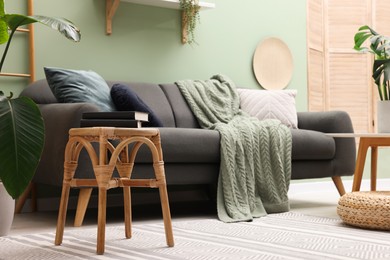 Photo of Living room with stool and sofa. Stylish interior design