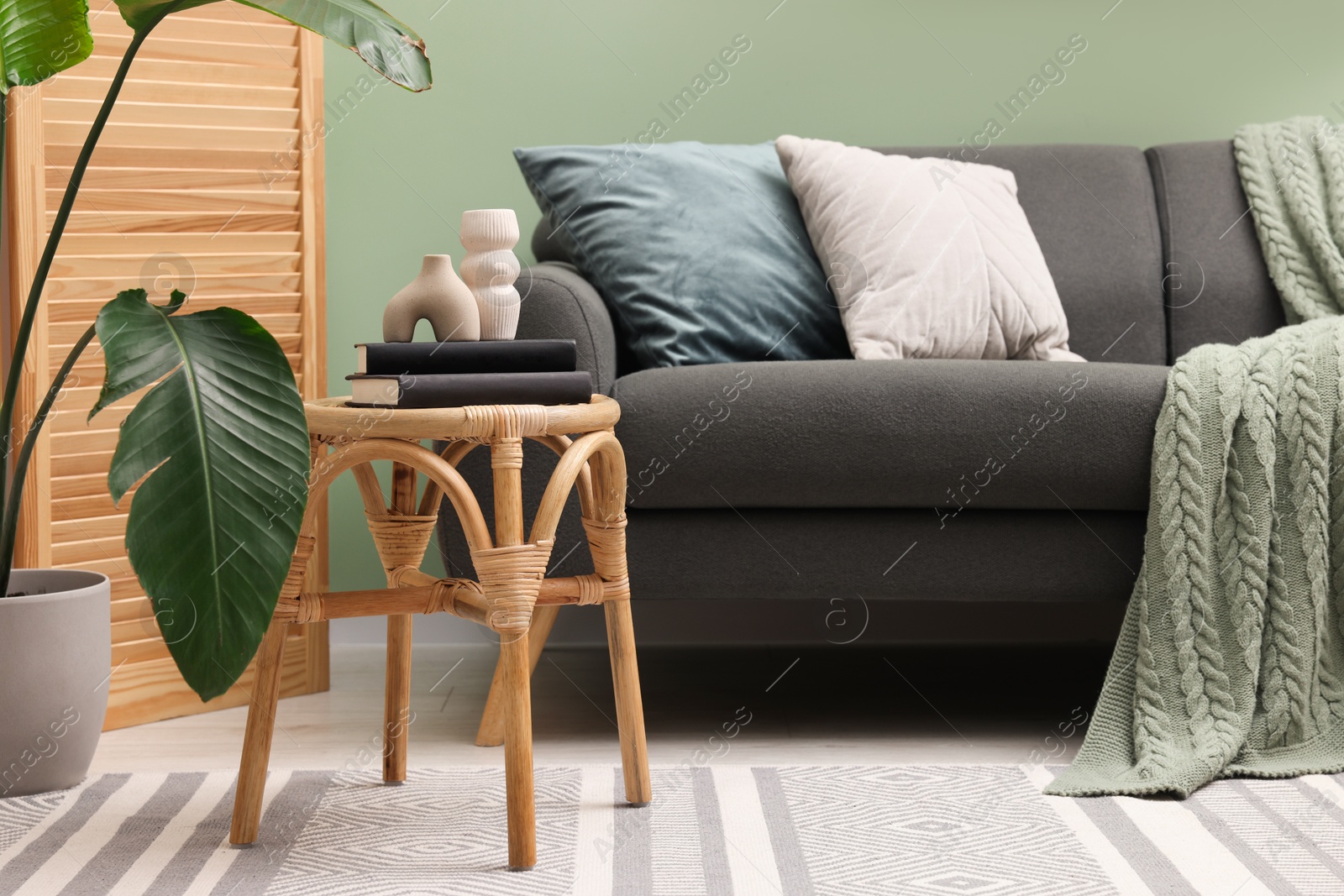 Photo of Living room with stool and sofa. Stylish interior design