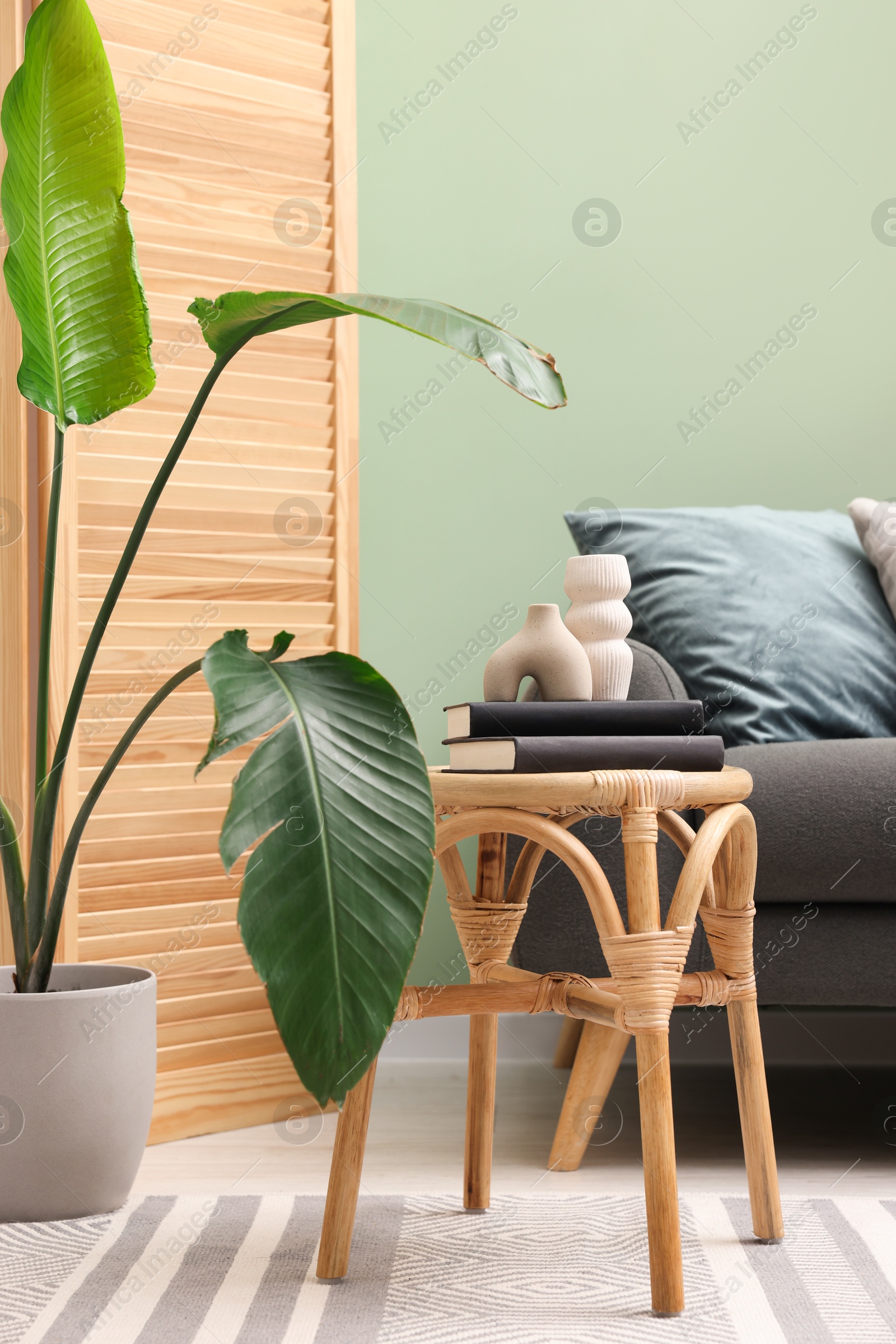 Photo of Living room with stool and sofa. Stylish interior design