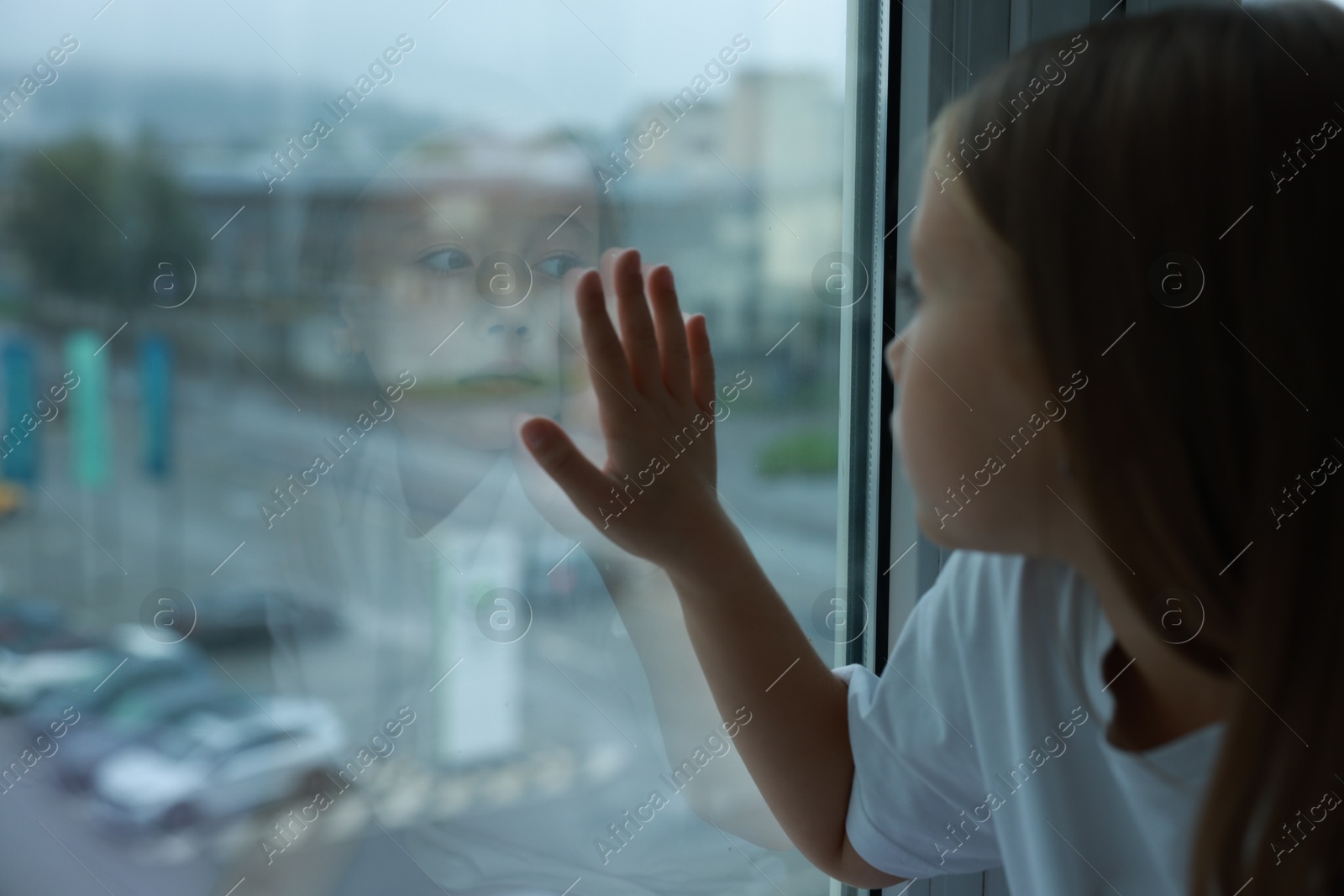 Photo of Autism concept. Lonely little girl near window at home, space for text