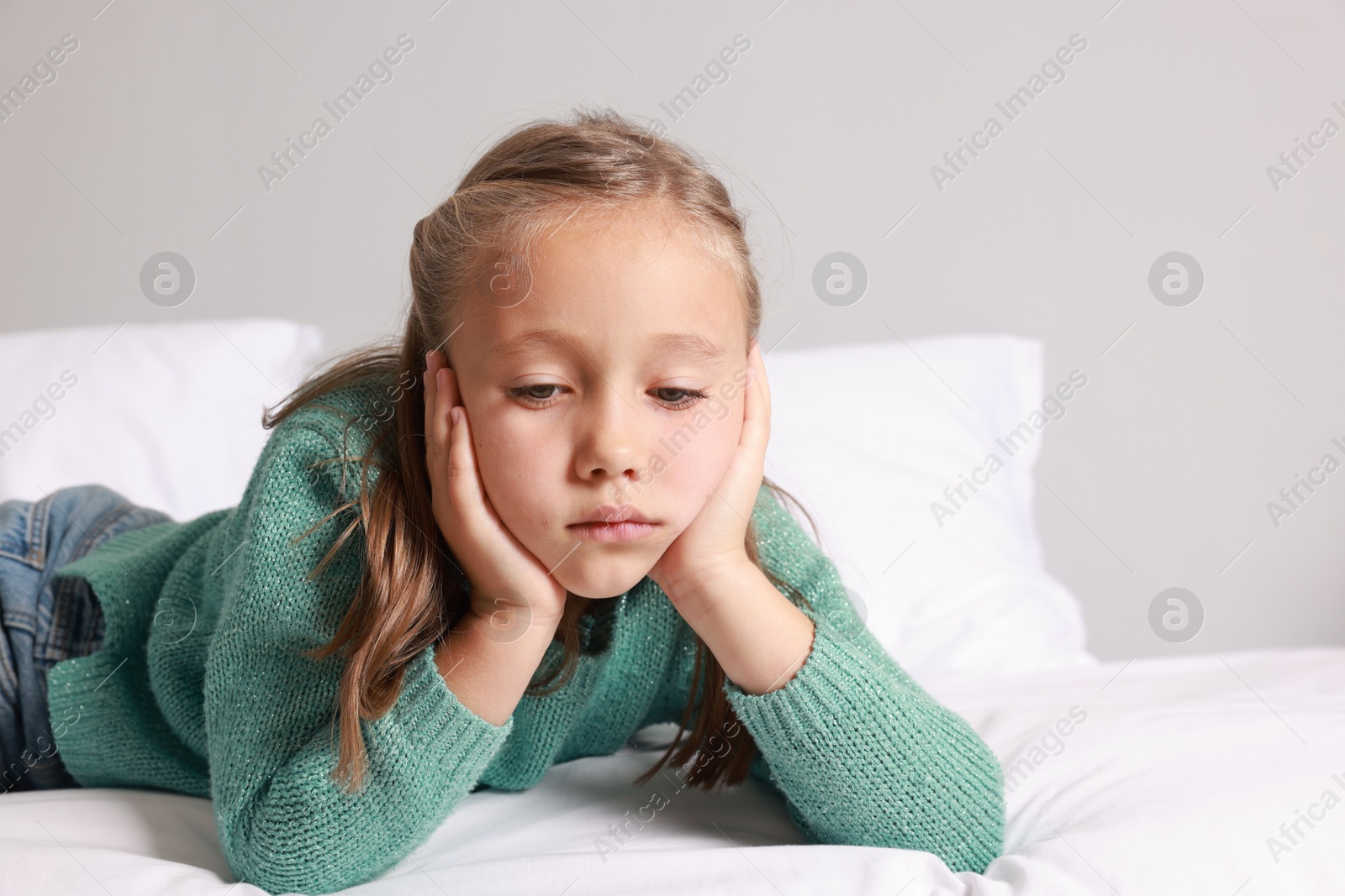 Photo of Autism concept. Lonely little girl on bed at home