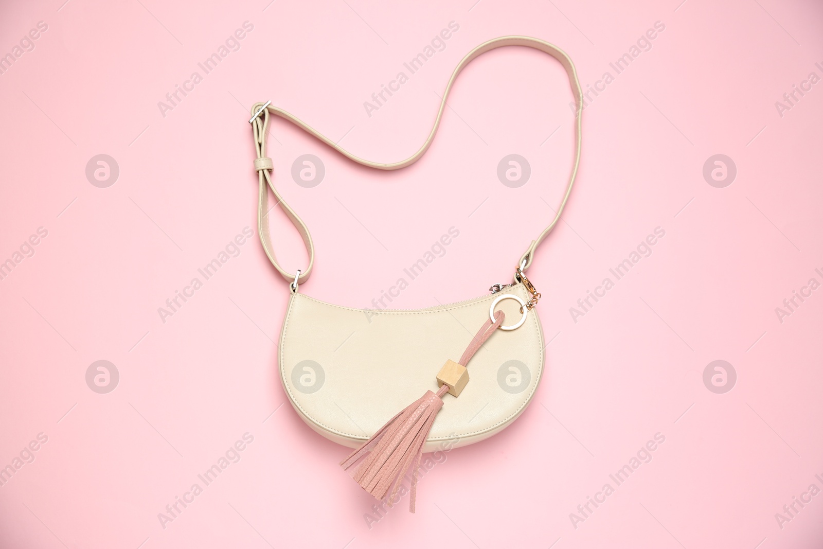 Photo of Bag with leather keychain on pink background, top view