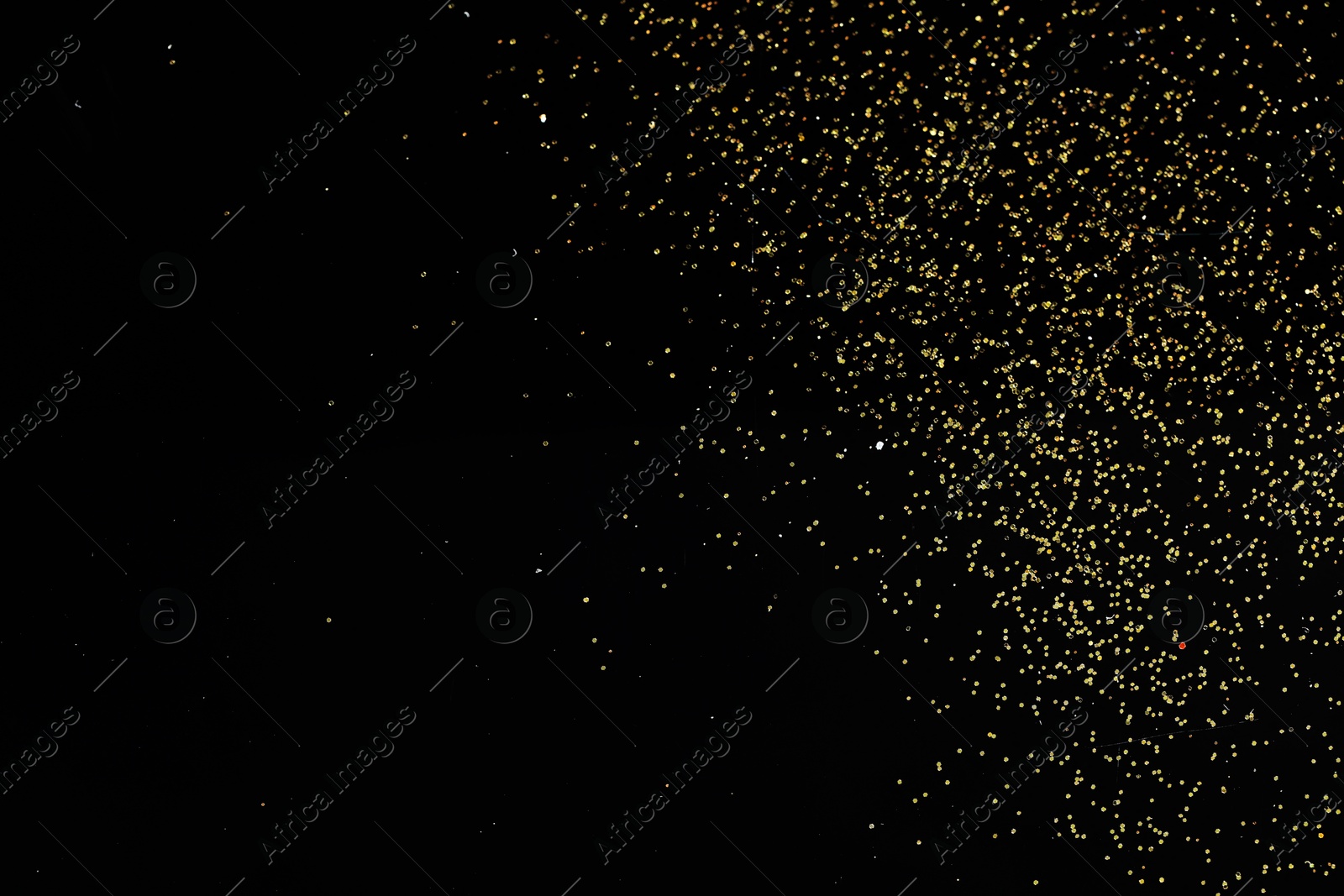 Photo of Beautiful shiny golden glitter on black background, top view