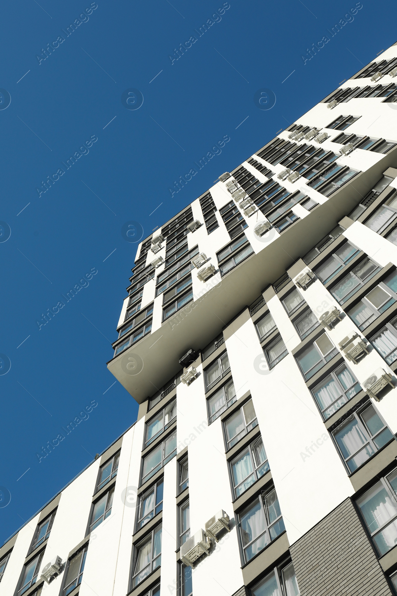 Photo of Exterior of modern building against blue sky, low angle view