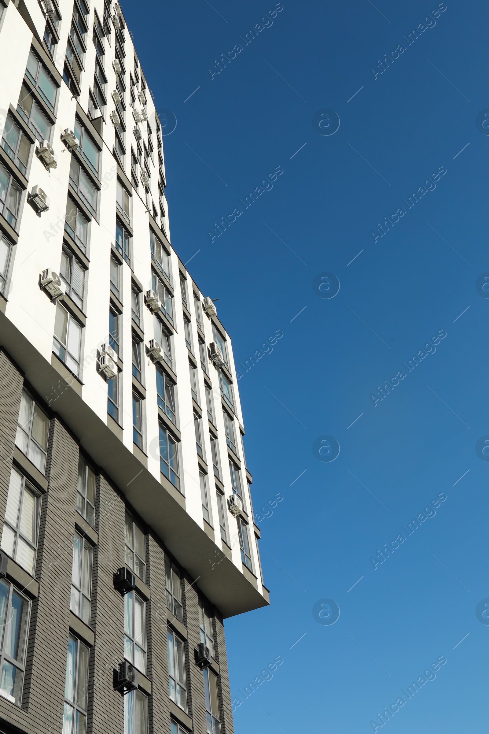 Photo of Exterior of modern building against blue sky, low angle view