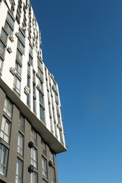 Photo of Exterior of modern building against blue sky, low angle view