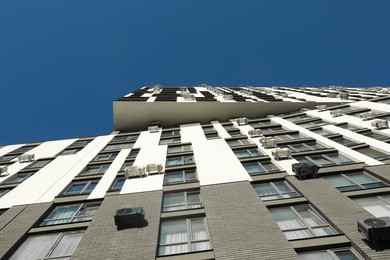 Photo of Exterior of modern building against blue sky, low angle view