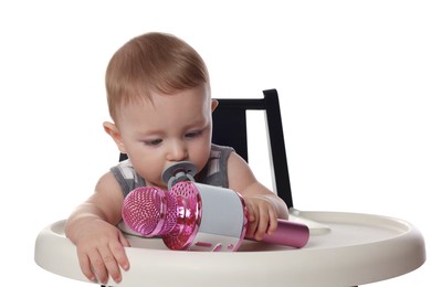 Cute little baby with pacifier and microphone in high chair on white background