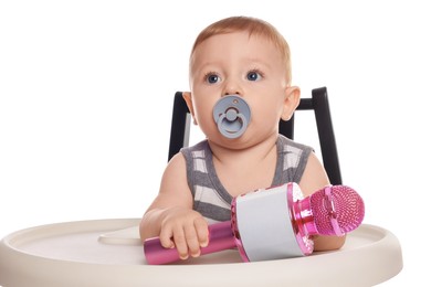 Photo of Cute little baby with pacifier and microphone in high chair on white background