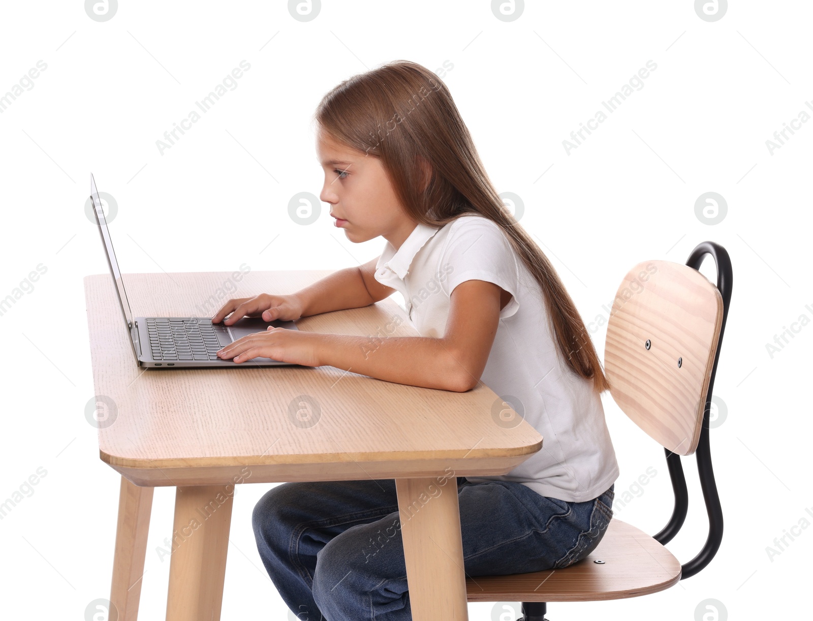 Photo of Girl with incorrect posture using laptop at wooden desk on white background