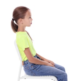 Girl with correct posture sitting on chair against white background