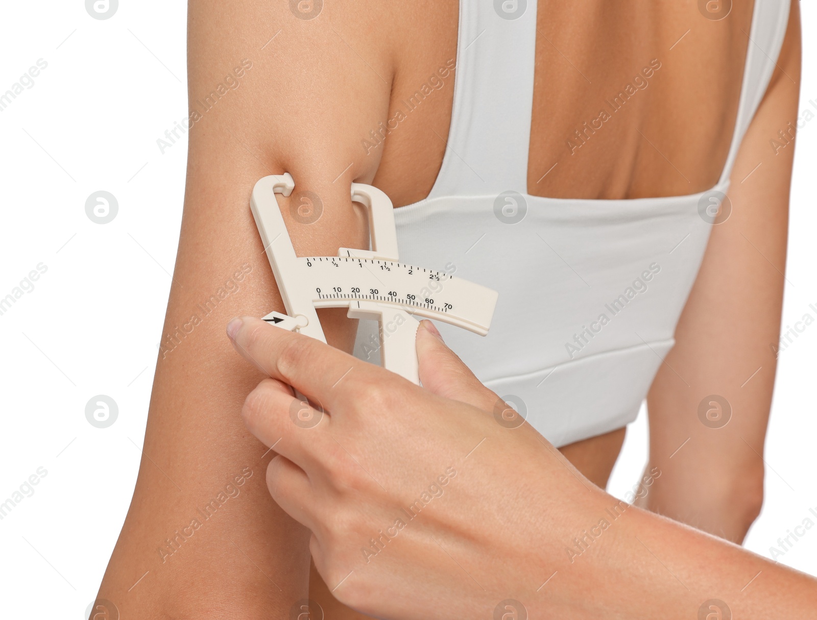 Photo of Nutritionist measuring woman's body fat with caliper on white background, closeup