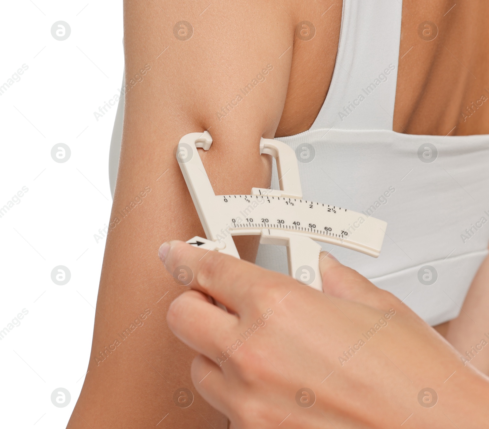 Photo of Nutritionist measuring woman's body fat with caliper on white background, closeup