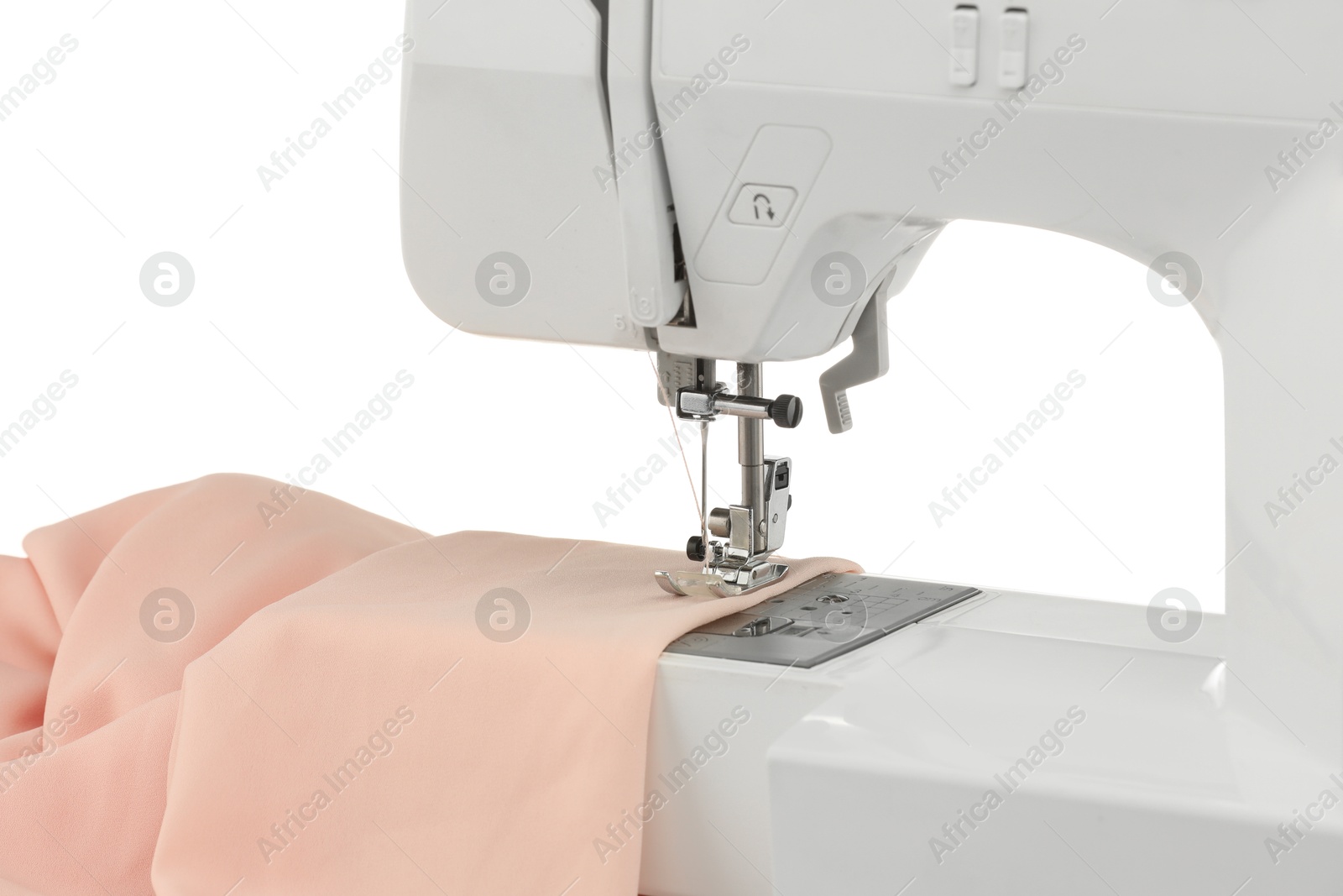 Photo of Sewing machine with cloth isolated on white