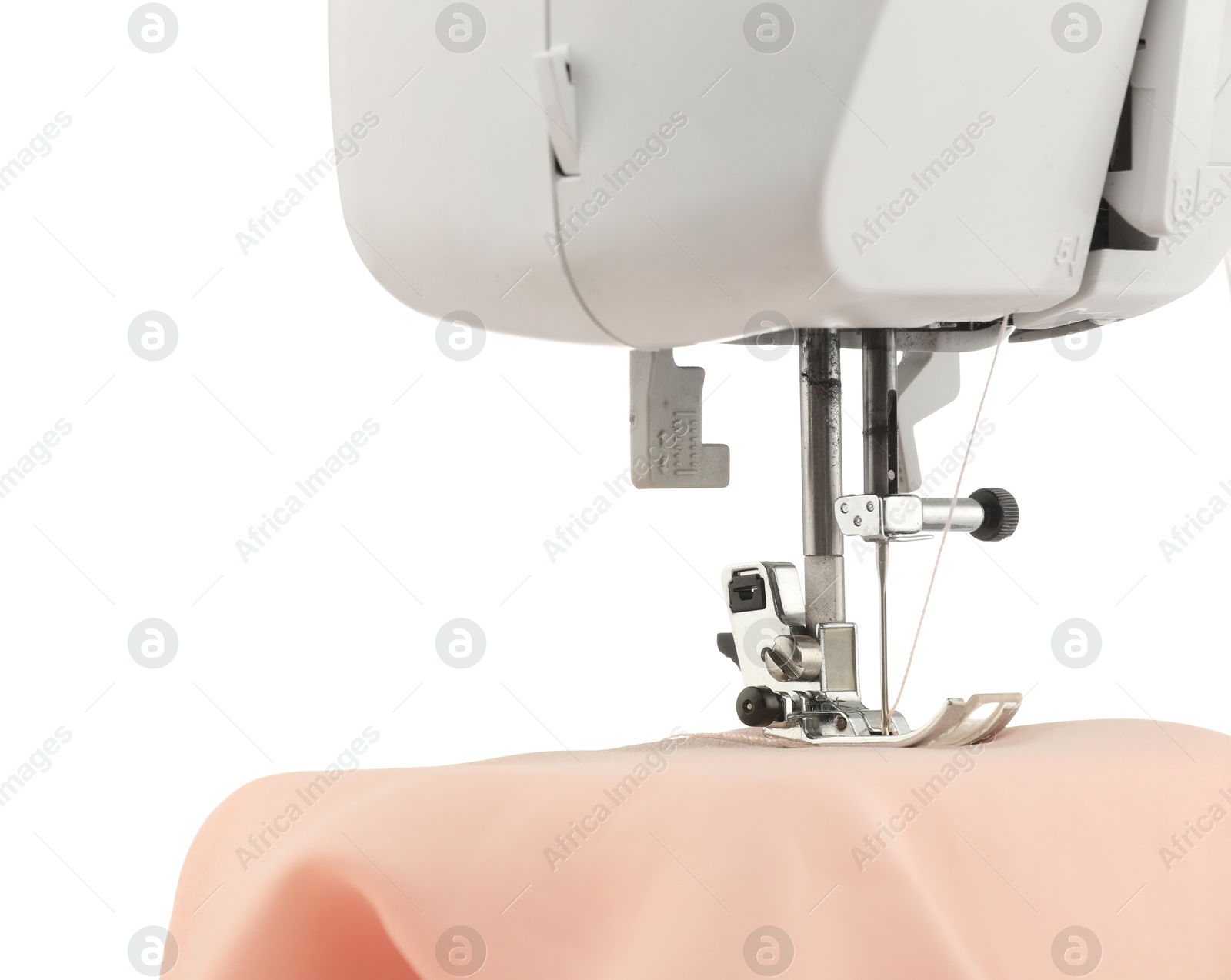 Photo of Sewing machine with cloth isolated on white