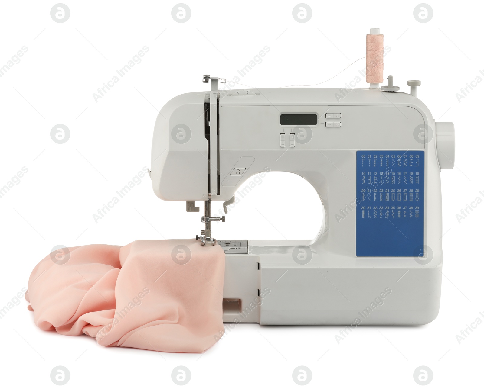 Photo of Sewing machine with cloth isolated on white