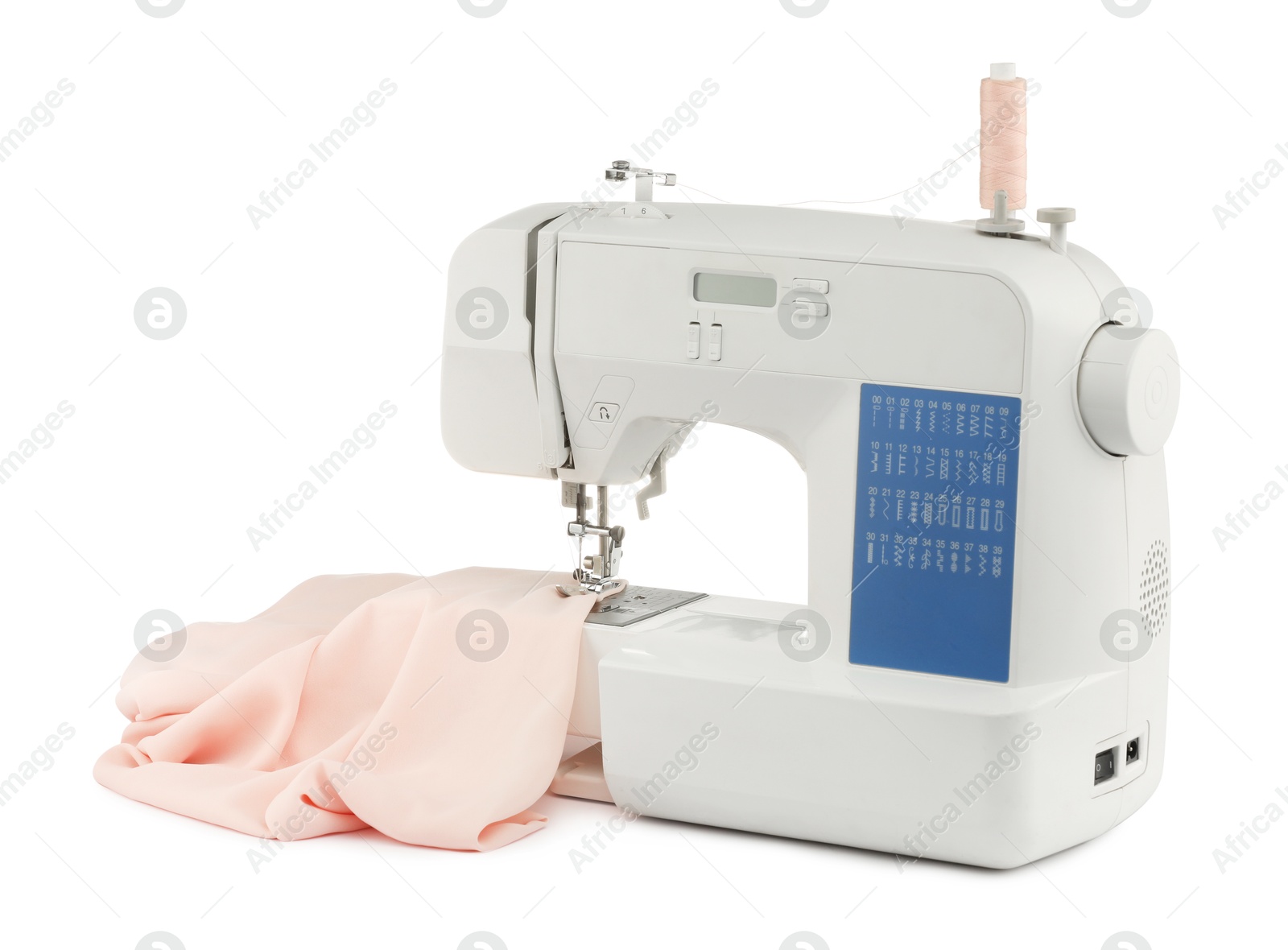 Photo of Sewing machine with cloth isolated on white