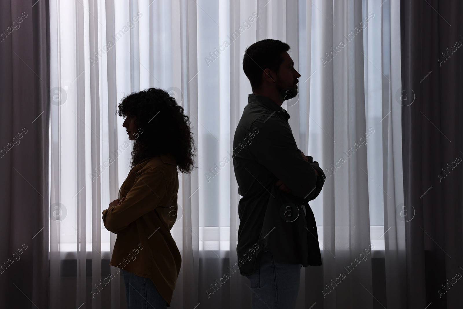 Photo of Couple having quarrel indoors at night. Relationship problems