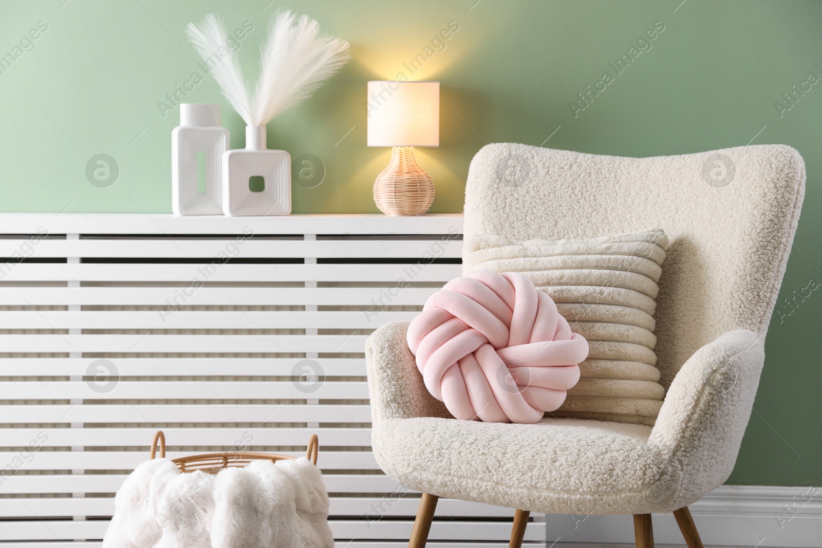 Photo of Decorative pillows on light armchair in living room