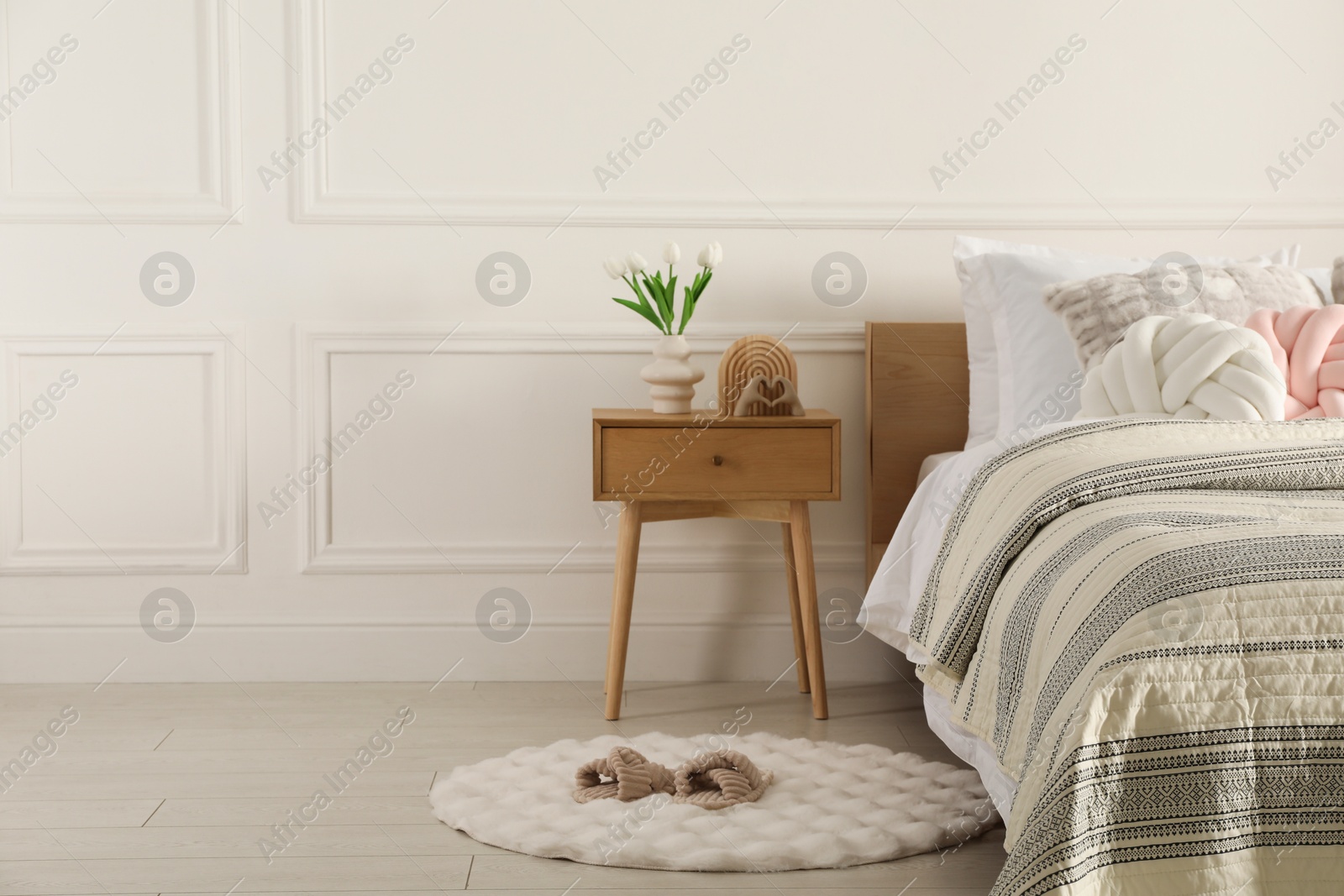 Photo of Bed with beautiful cushions in room, space for text