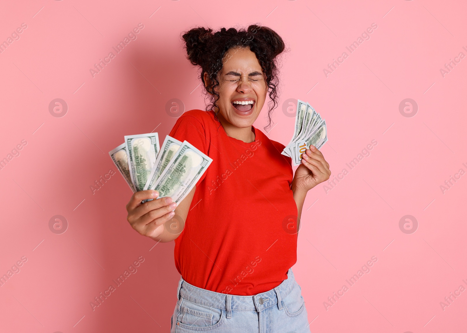 Photo of Happy woman with dollar banknotes on pink background