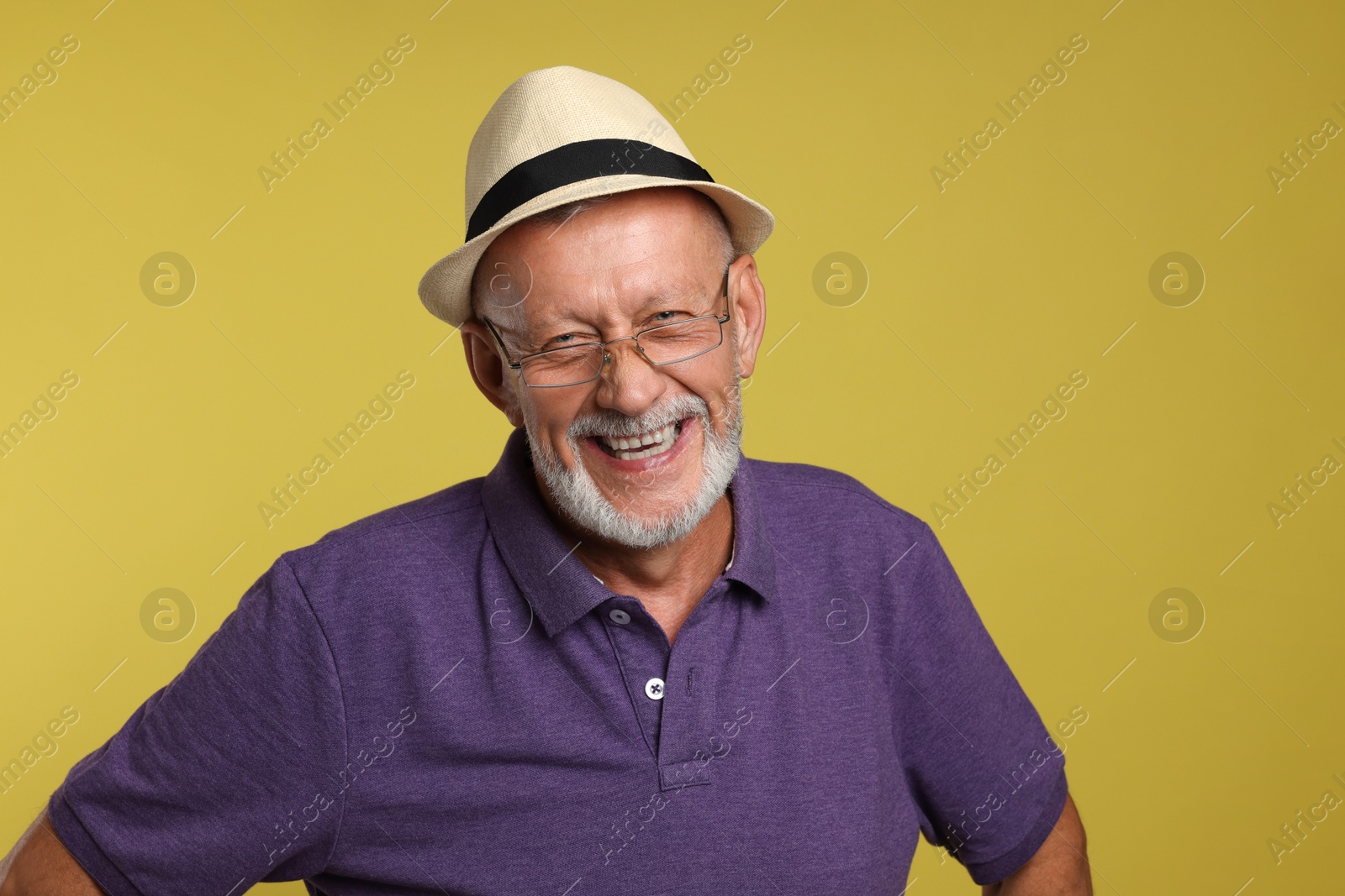 Photo of Portrait of happy senior man on yellow background