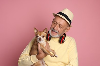 Photo of Portrait of handsome senior man with Chihuahua dog on pink background