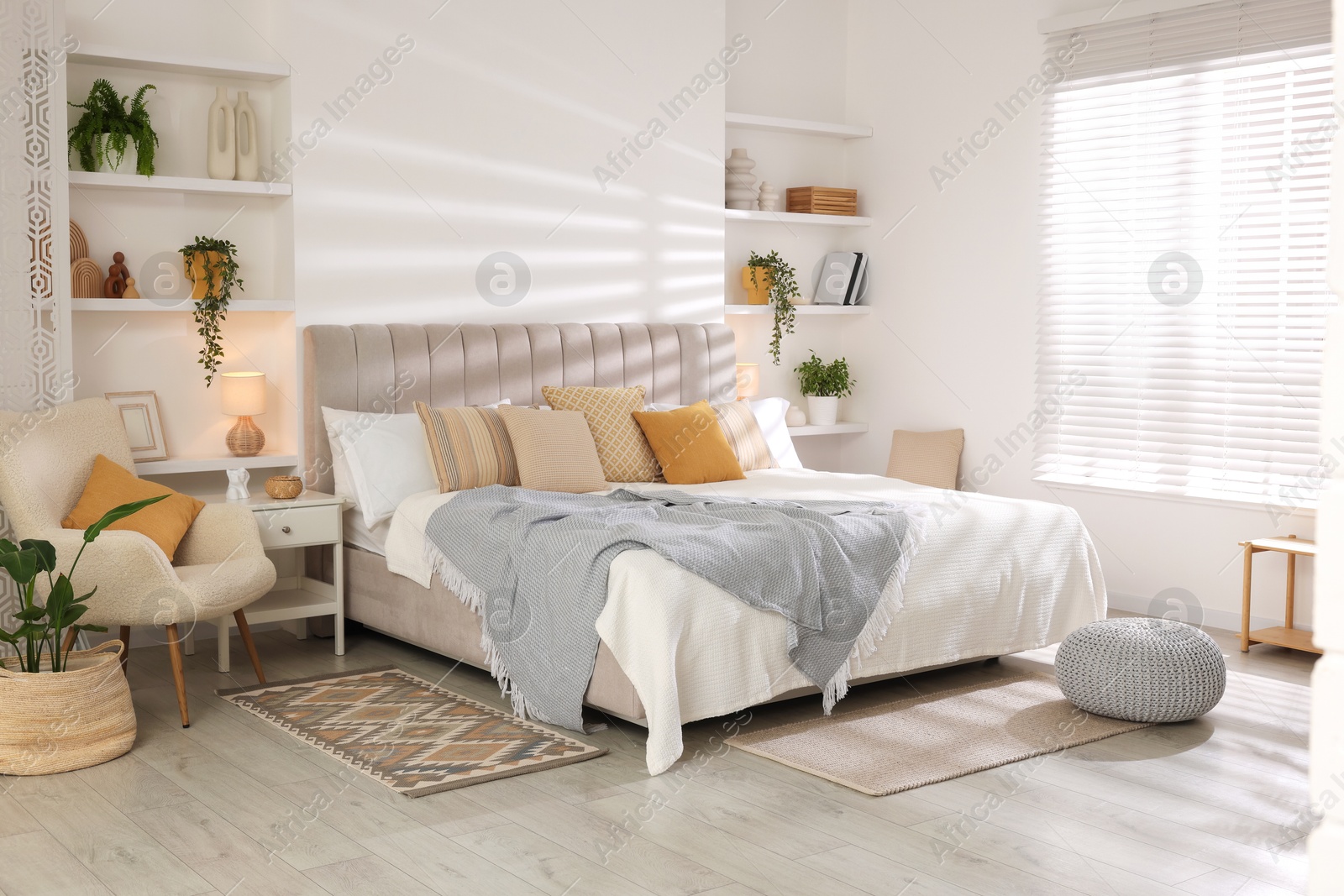 Photo of Comfortable large bed in beautiful room. Interior design