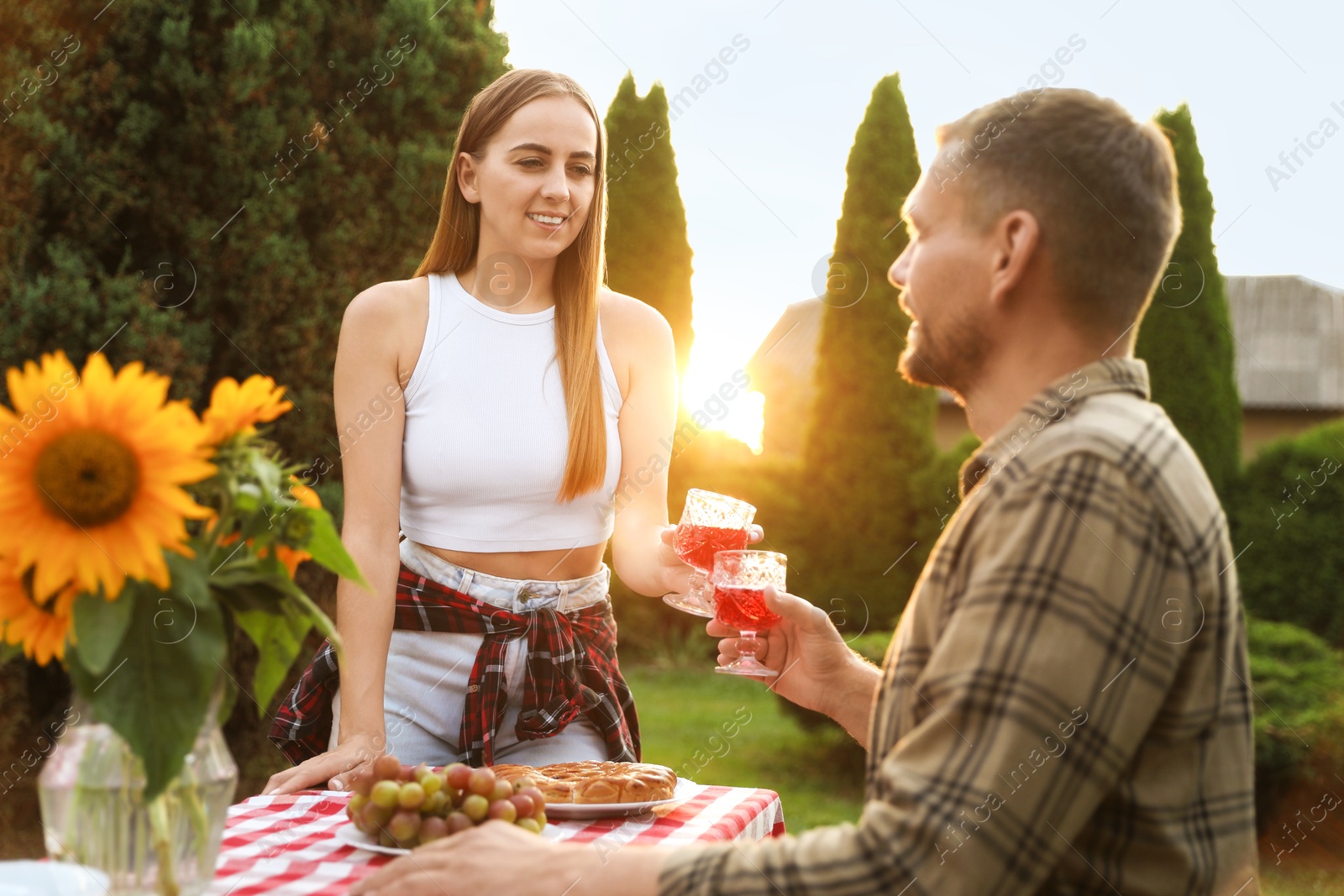 Photo of Couple having romantic date at table in garden