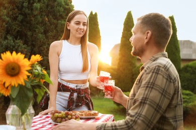 Photo of Couple having romantic date at table in garden