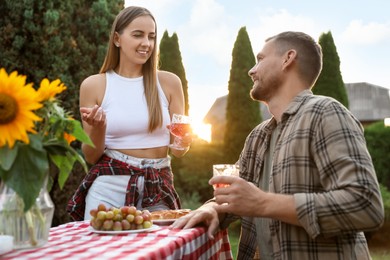 Photo of Couple having romantic date at table in garden