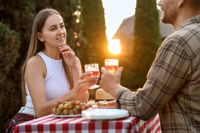 Photo of Couple having romantic date at table in garden