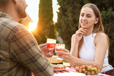 Photo of Couple having romantic date at table in garden