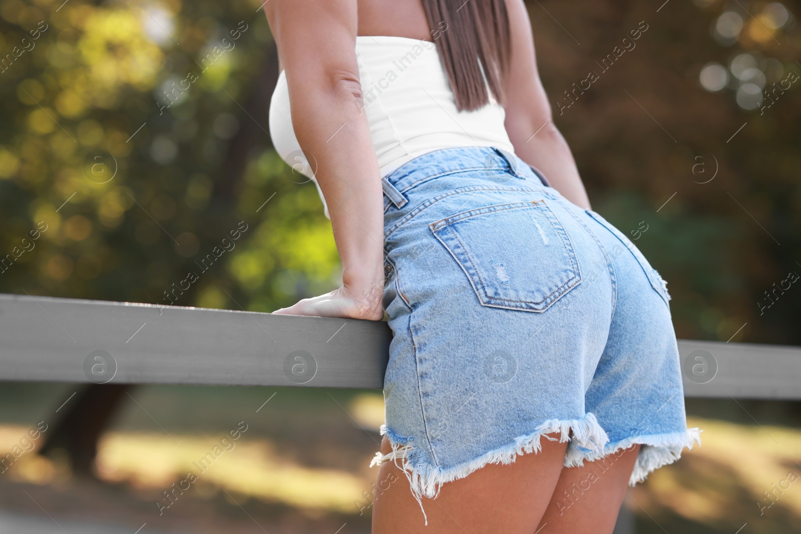 Photo of Woman wearing stylish denim shorts outdoors, closeup