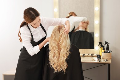 Photo of Hair cutting. Professional hairdresser working with client in salon