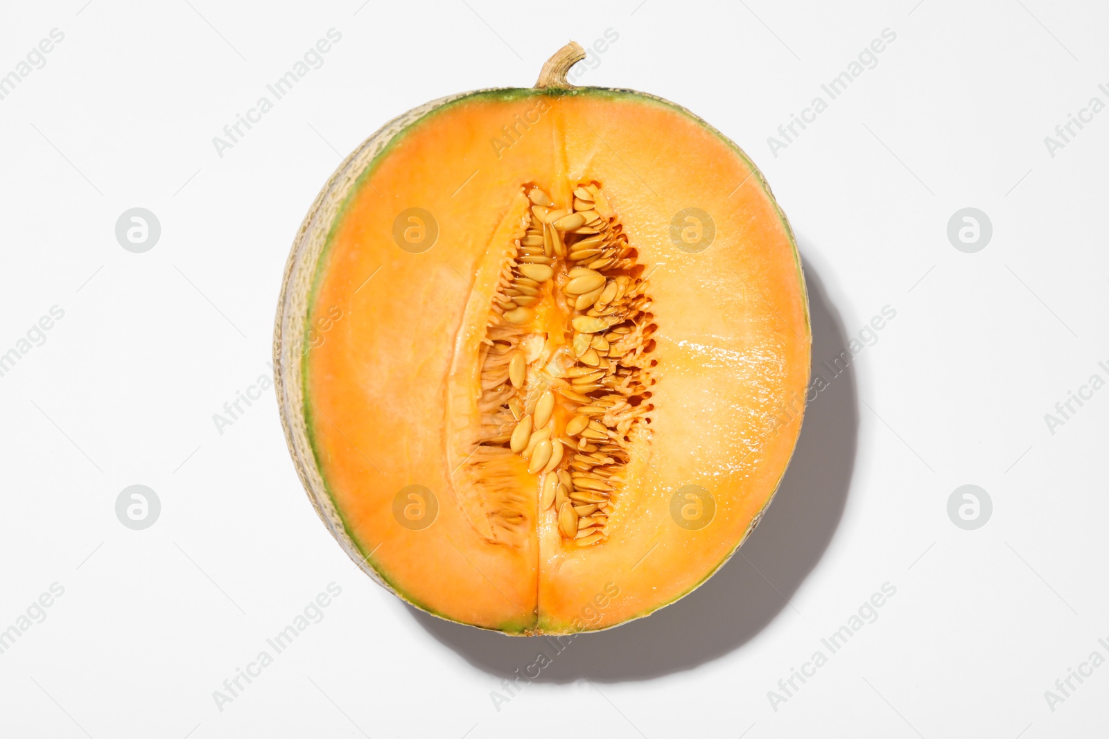 Photo of Half of fresh Cantaloupe melon on white table, top view