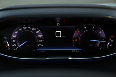 Photo of Speedometer on dashboard inside of modern luxury car, closeup